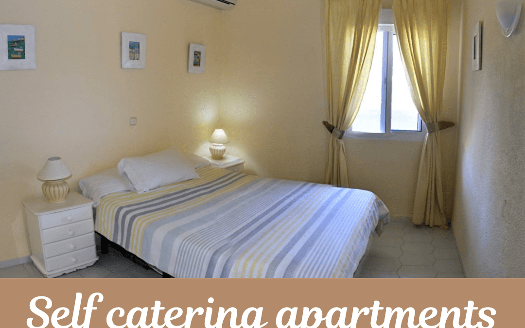 A cosy bedroom with a double bed, striped bedding, bedside tables with lamps, framed pictures on cream walls, and yellow curtains—perfect for those seeking self-contained flats Benalmadena. Text: Self-catering flats Travel Spain.